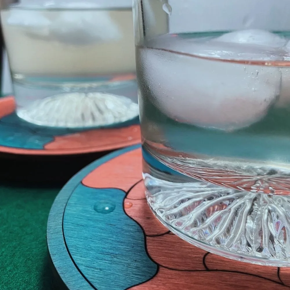 Original Petit Gaudí campaign photo of two Trencadís wooden puzzles being used as drinks coasters